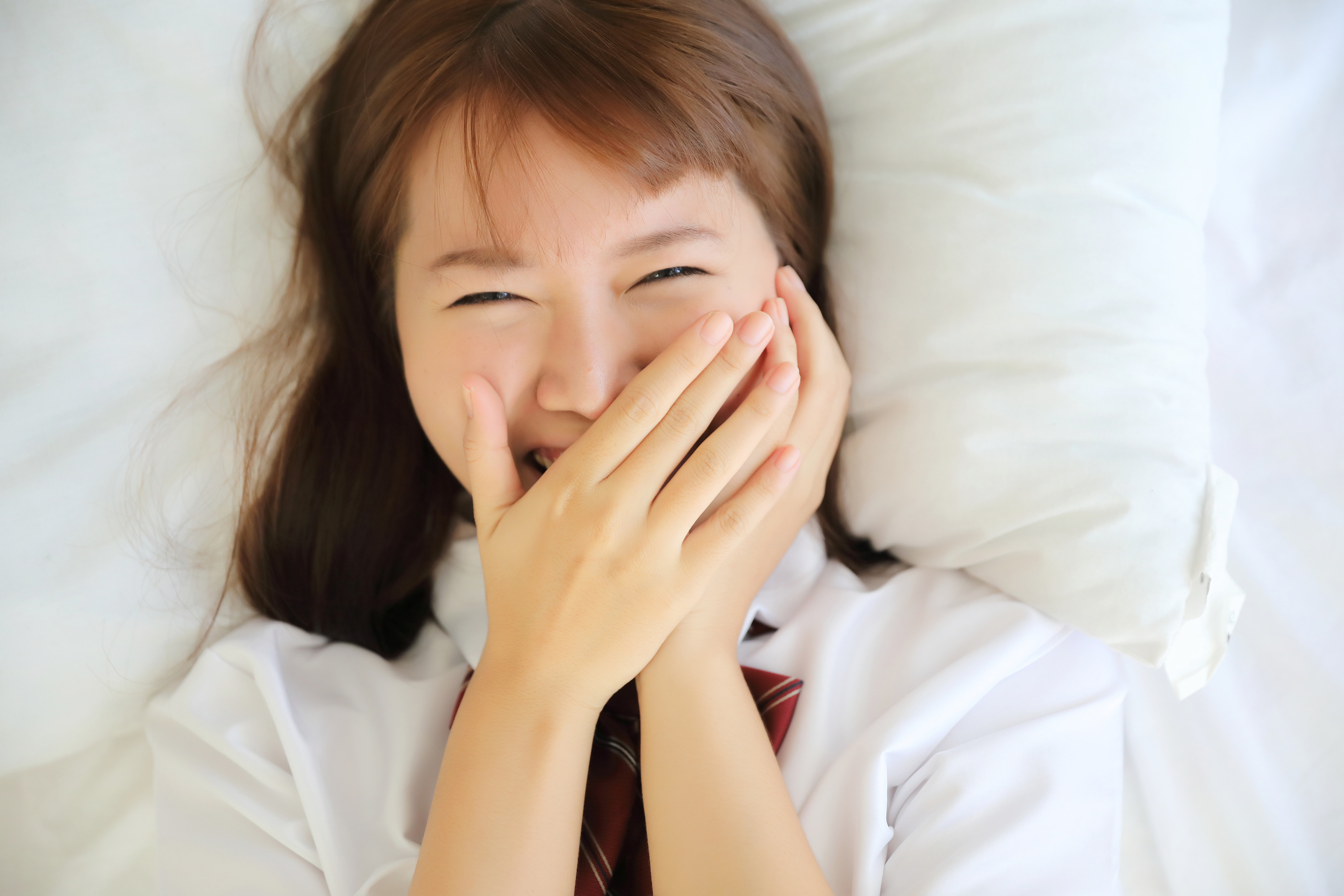 Japanese School Girl Smiling in Bed